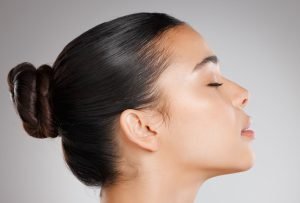 Side profile of a woman highlighting facial contours and skin appearance.